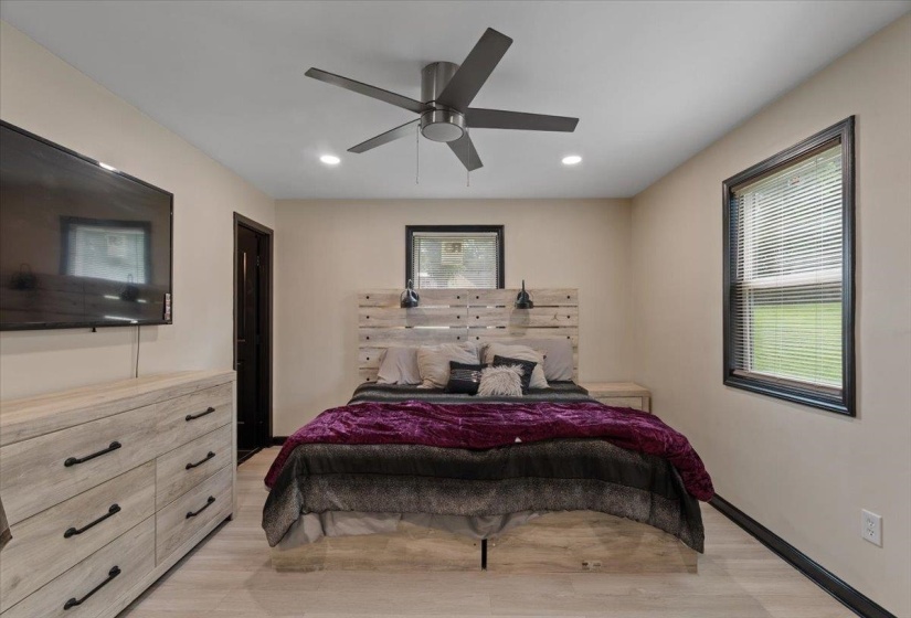 Bedroom featuring light wood-finish flooring, recessed lighting, and a contemporary ceiling fan