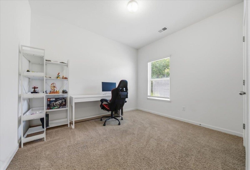 Room featuring neutral wall paint, carpet flooring, a single window with blinds, and a ceiling-mounted light fixture