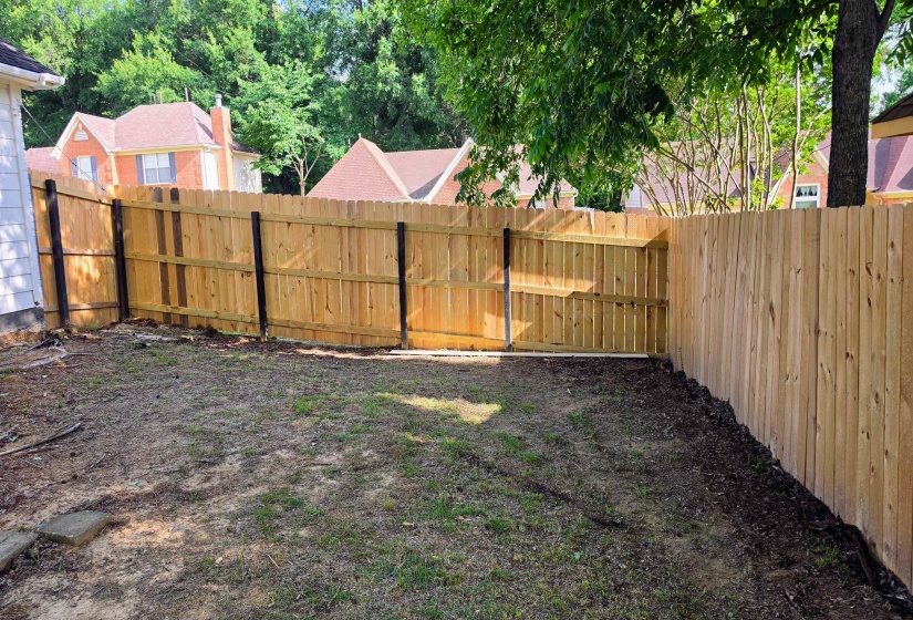 Fenced backyard with wood privacy fencing