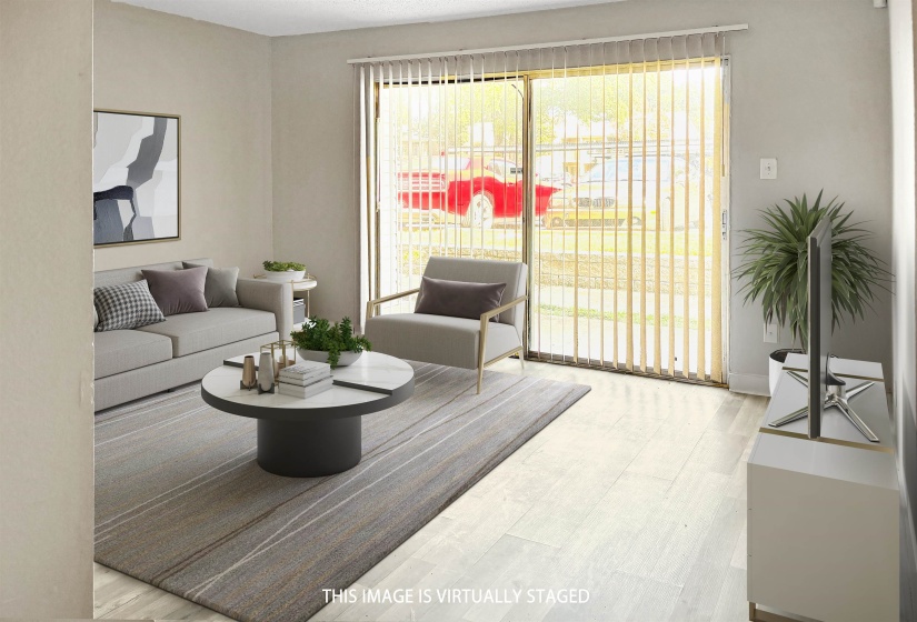 Exterior featuring durable siding, a private balcony with wood railing, and a ground-level patio