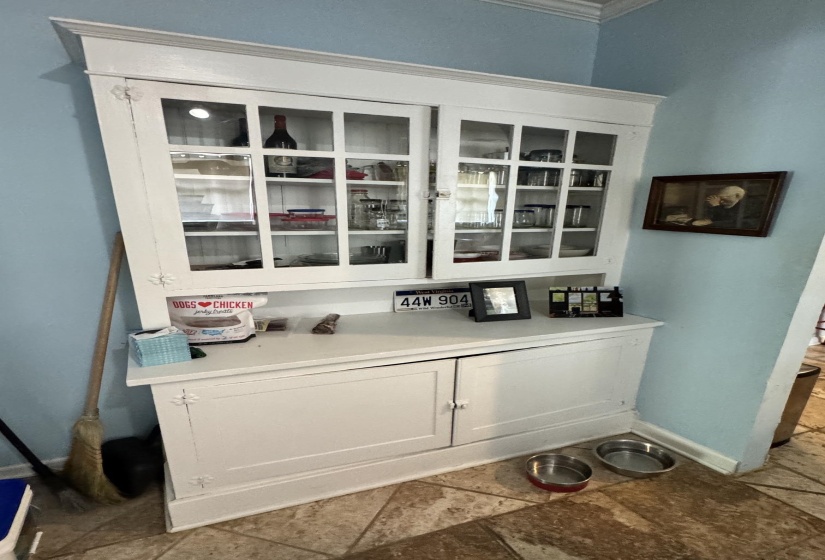 White built-in cabinetry with glass-front upper doors and solid lower panel doors