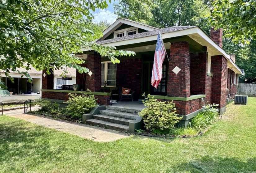 Craftsman-style home featuring a brick exterior and a covered front porch