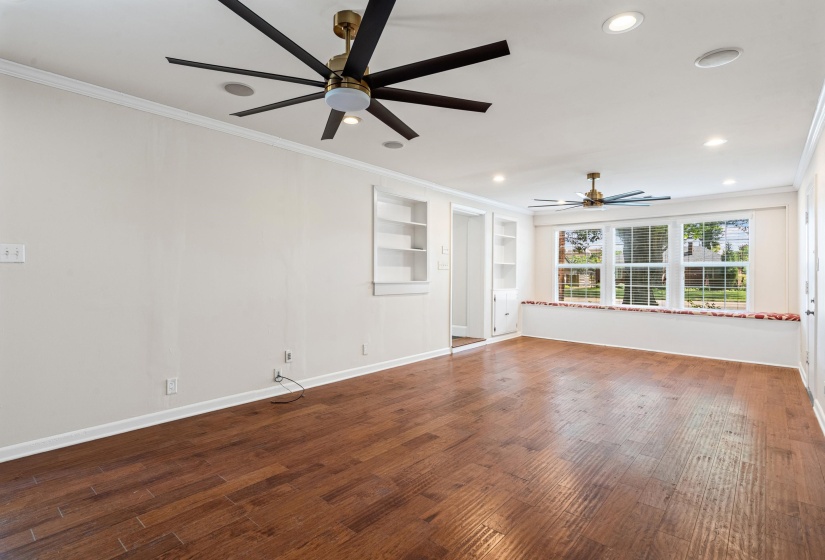 Breakfast area in the front of the room with the built-in cabinets and bench below the windows.