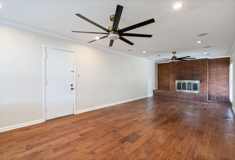 Spacious rear part of the 28x13 den has a second fireplace.  In ceiling speakers, custom ceiling fans, and recessed cabinet make this a great room for entertaining.