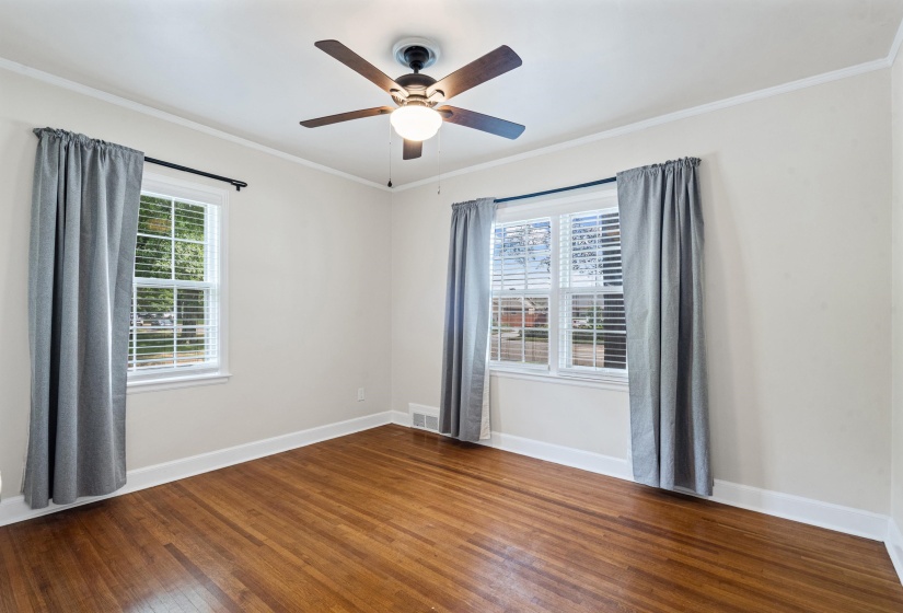 Front bedroom with natural hardwood floors, smooth ceiling and lots of natural light.