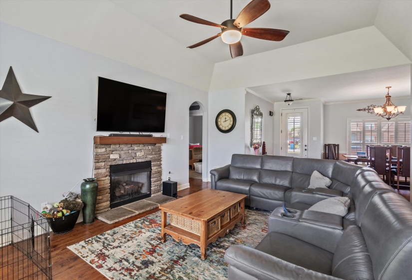 Living area featuring vaulted ceilings and wood-finish flooring