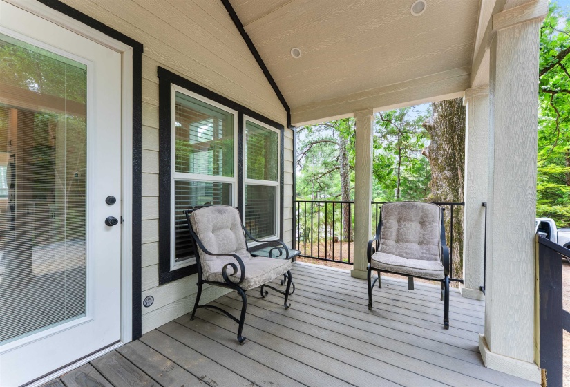 Covered outdoor deck with light wood-finish flooring