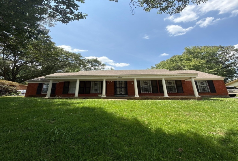 Brick exterior with a covered front porch supported by white columns