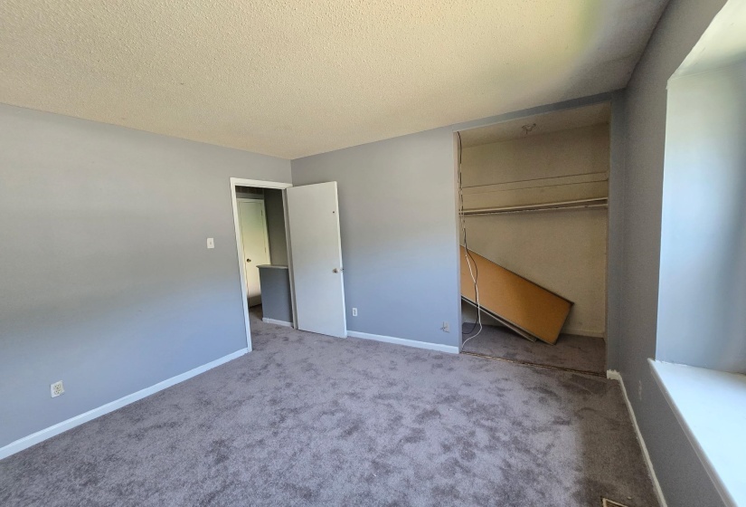 Grey carpeted room with light grey walls