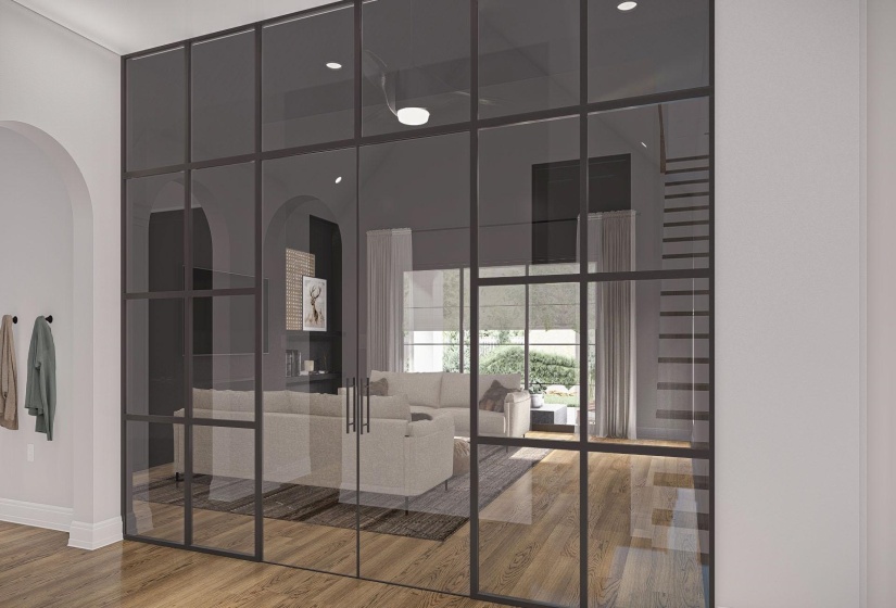 Steel-framed glass partition featuring double doors with matte black hardware, wood-finish flooring, a ceiling fan with integrated lighting, and an arched entryway