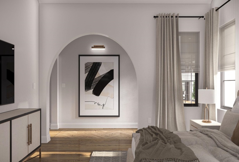 Bedroom featuring wood-finish flooring, two large windows with roller shades, and an arched doorway