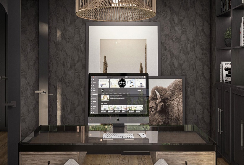 Office space featuring dark textured wall covering, a built-in desk with a dark countertop and wood-finish drawers, and integrated dark cabinetry with open shelving and recessed lighting