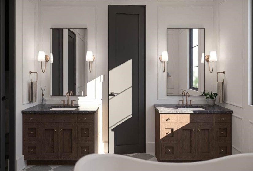 Dual wood-finish vanities with dark countertops and integrated sinks