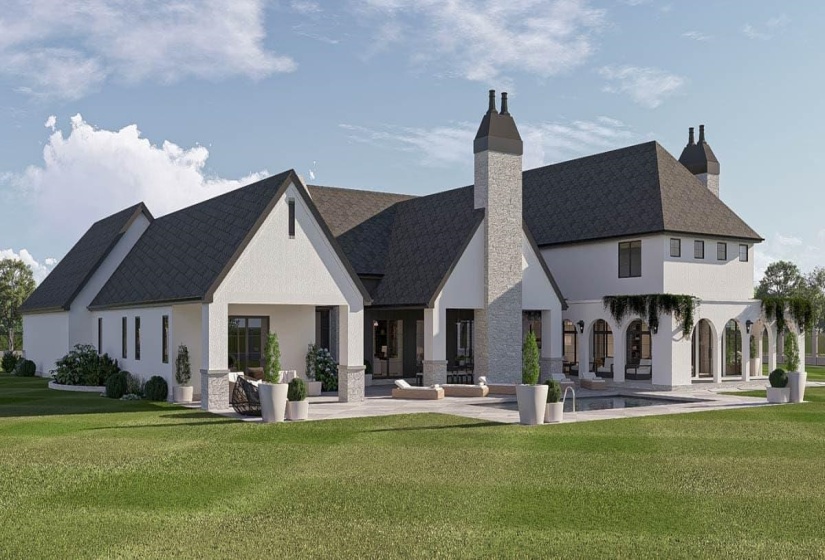 Expansive stucco residence featuring multiple gabled roofs with dark shingles, a large patio, and a swimming pool