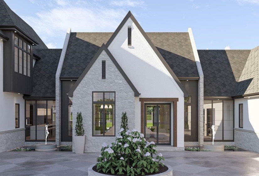 Architectural facade featuring a combination of light-toned stone and white stucco, accented by dark-framed windows and a dark shingle roof