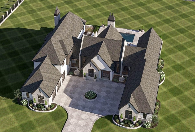 Grand estate featuring a multi-gabled roofline and a patterned paver driveway