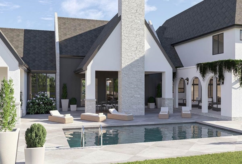 Expansive outdoor living area featuring a rectangular swimming pool, light-toned paver decking, and a covered patio with arched entries