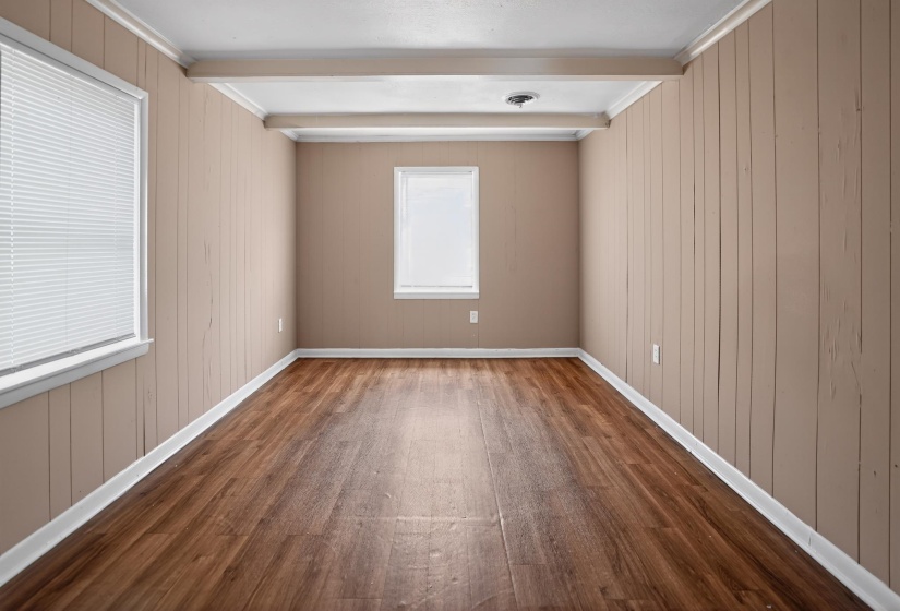 Room featuring rich wood-finish flooring