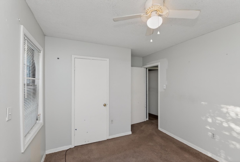 Light gray walls complement the brown carpeted flooring