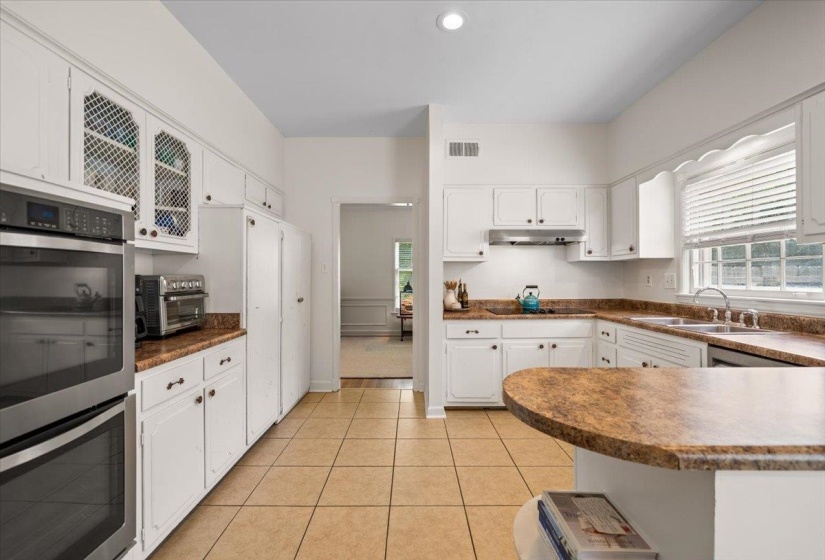 Kitchen featuring white cabinetry, light-toned tiled flooring, and neutral-toned countertops