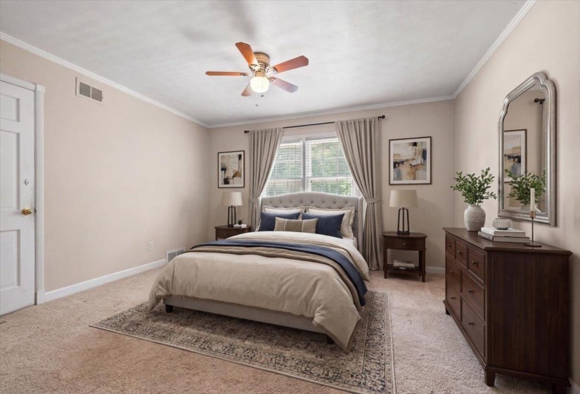 Virtually staged upstairs bedroom; Carpeted room featuring a ceiling fan with integrated lighting, a window with blinds, and white trim molding; currently being used as exercise room.