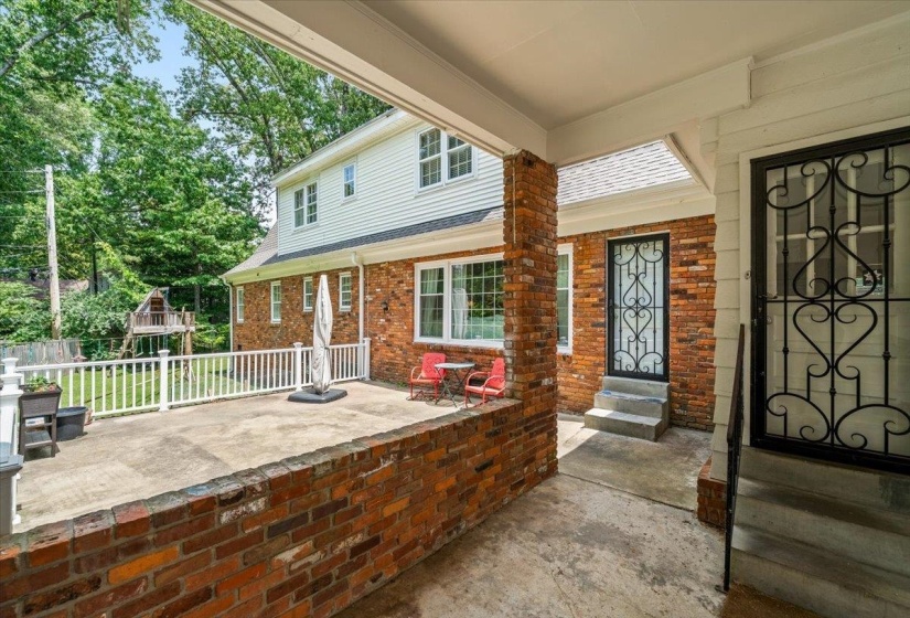 Brick exterior with white siding accents and multiple windows