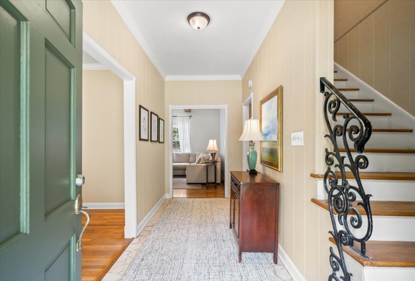 Entryway featuring a decorative wrought iron staircase railing to second floor
