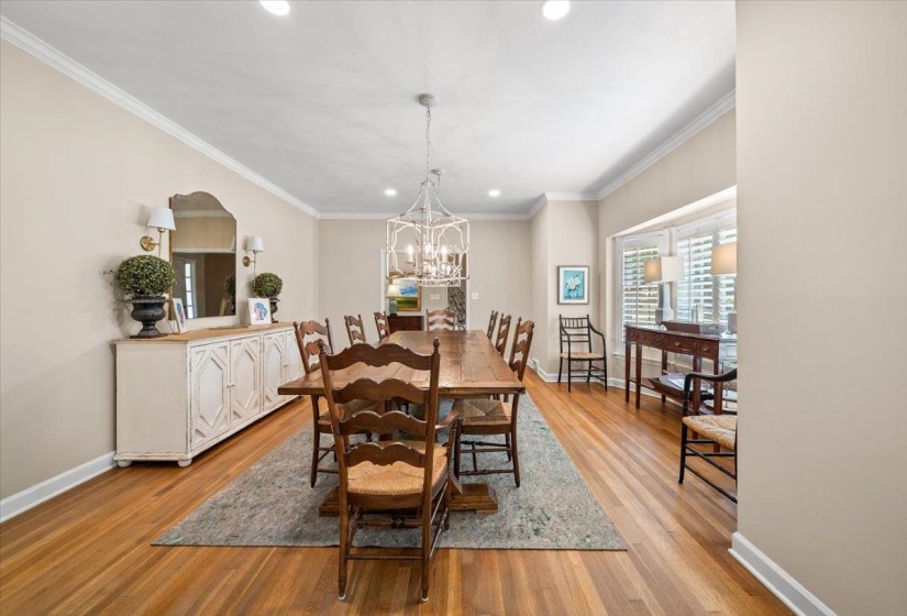 Spacious dining room featuring a decorative chandelier, recessed lighting, and hardwood flooring