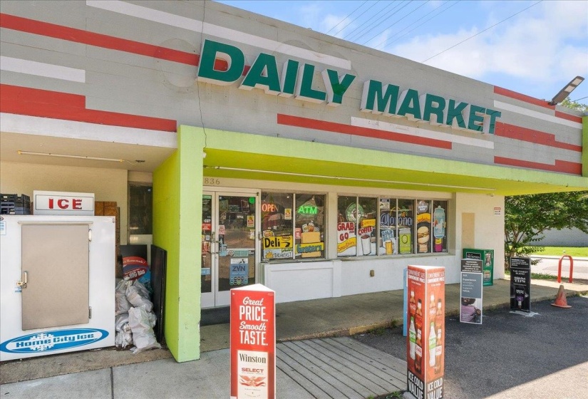 Commercial storefront with prominent exterior signage and a striped fascia