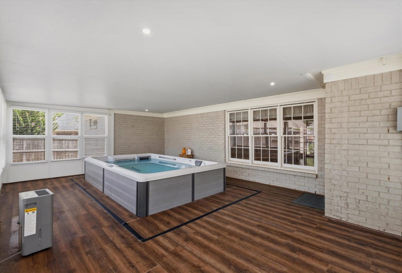 Indoor spa area featuring a large, built-in swim spa