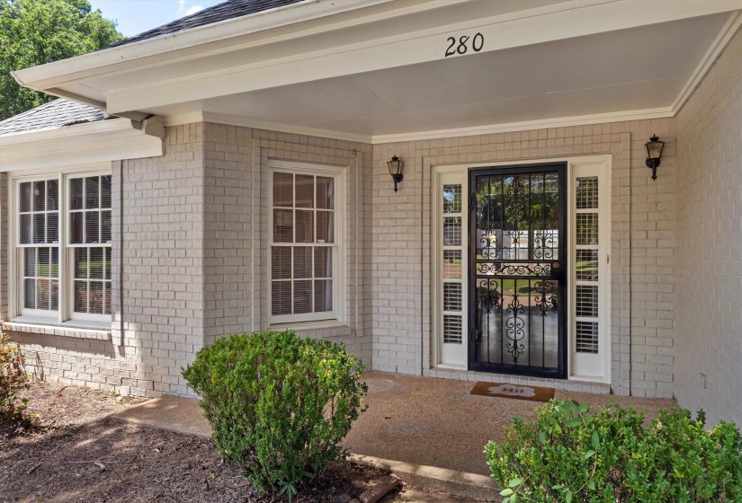 Brick exterior with white trim and a covered front entry