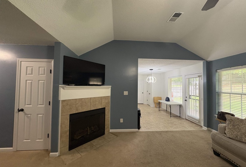 Living area featuring a gas fireplace with a tiled surround and white mantel