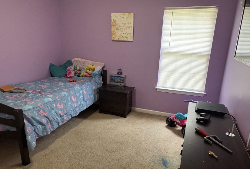 Carpeted room with a single window featuring horizontal blinds