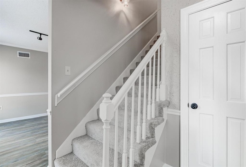Stairway with baseboards and wood finished floors