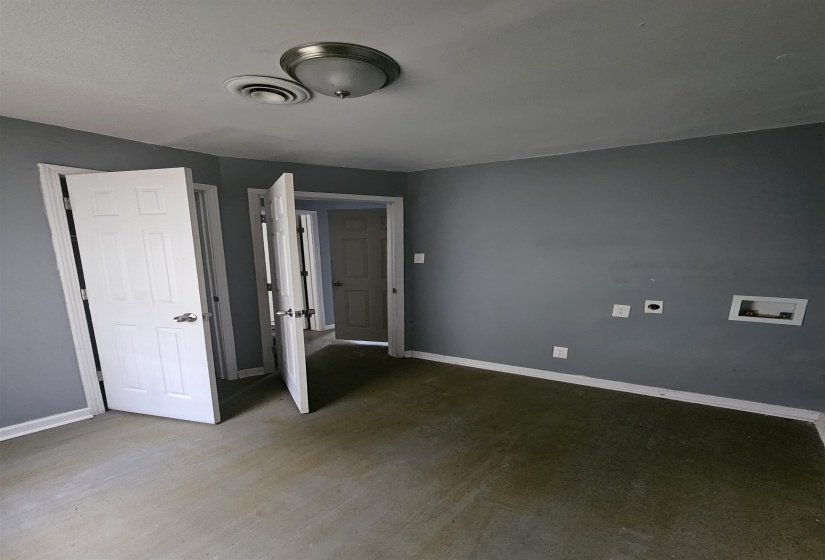 Room featuring a ceiling-mounted light fixture, HVAC vent, and light gray wall paint