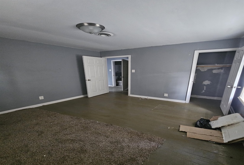 Room featuring painted flooring, grey wall finishes, and a flush mount ceiling light fixture