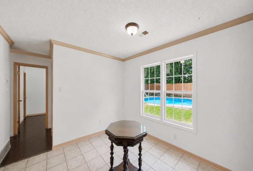 Eat in kitchen leading to hallway where 3 bedrooms, 2 baths, and laundry room awaits.  Some features are AI-enhanced.