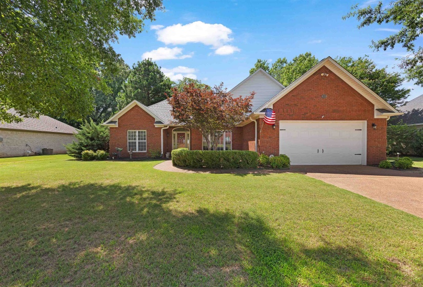 Traditional brick exterior with white trim and a gabled roofline