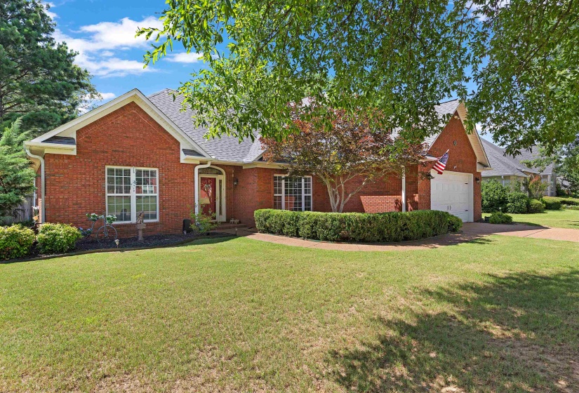 Brick exterior with a gabled roofline and attached garage