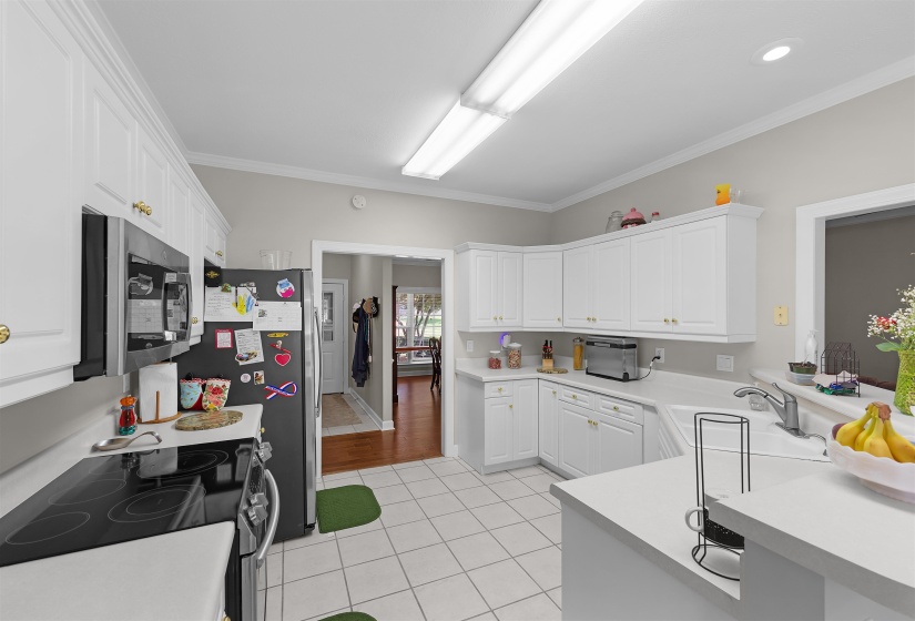 Kitchen featuring white cabinetry, white countertops, built-in appliances, recessed lighting, and tile flooring