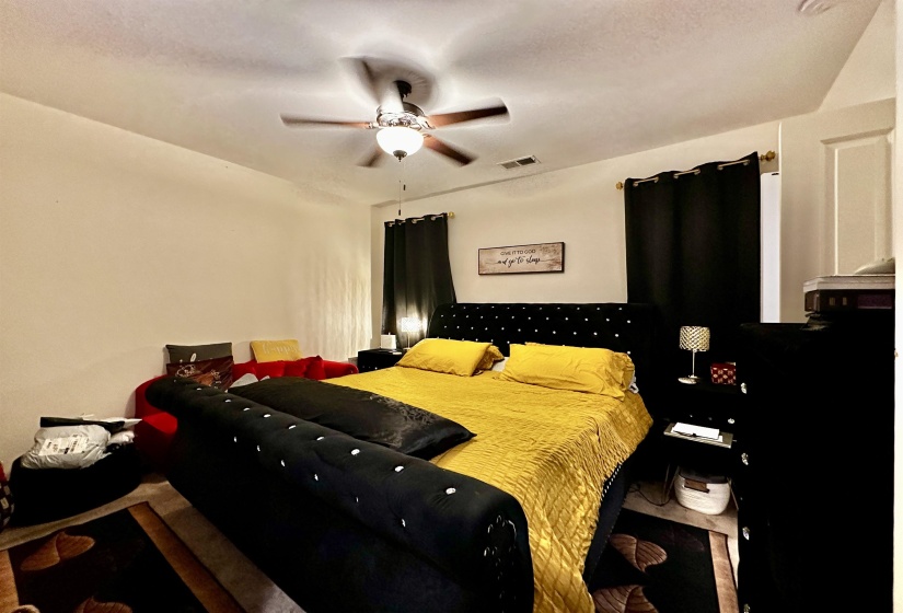 Recessed lighting and a ceiling fan fixture illuminate this interior space