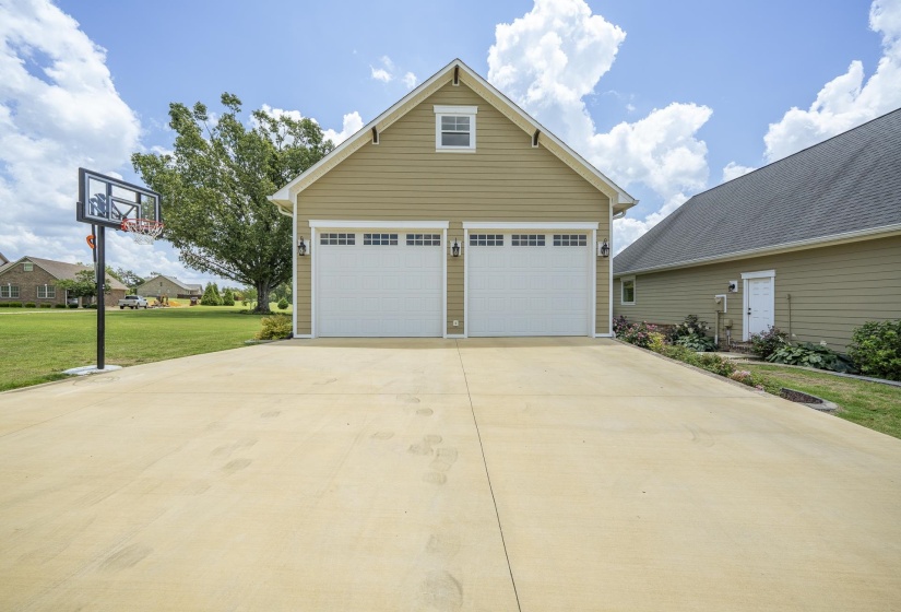 Two-car garage with overhead doors featuring window inserts