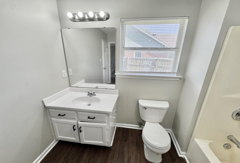 Bathroom with vanity, shower / bathtub combination, and dark wood-style floors