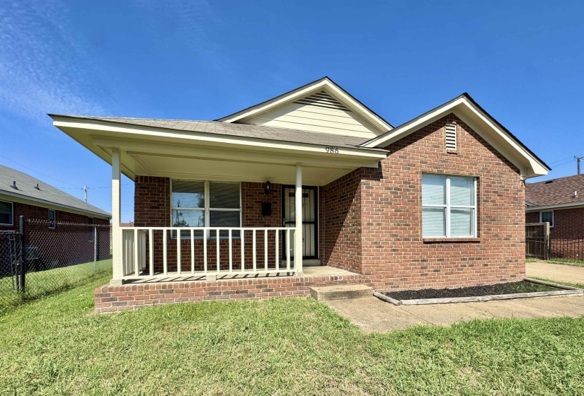 Single story home with brick siding and a porch