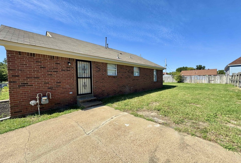 Back of house featuring brick siding, a patio area, and entry steps