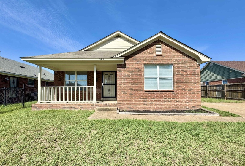 Ranch-style home featuring a porch and brick siding