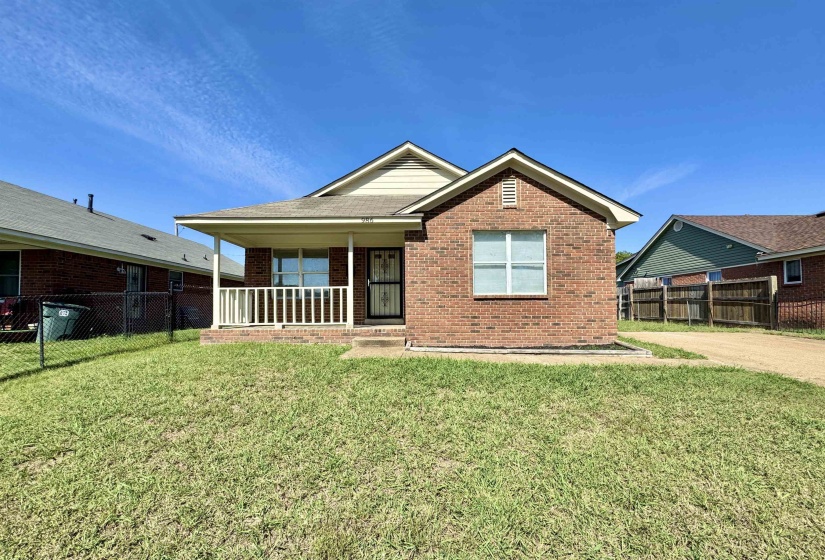 View of front of house featuring brick siding and covered porch