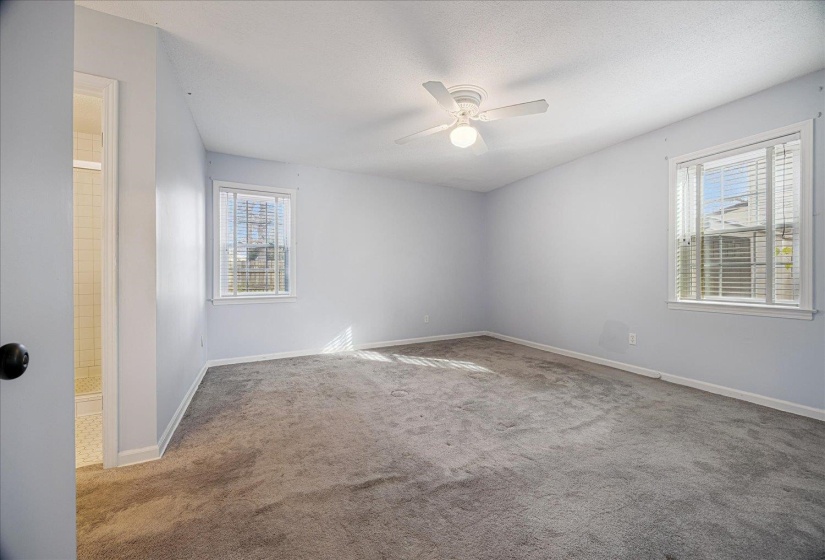 Spare room featuring carpet floors, ceiling fan, and a textured ceiling