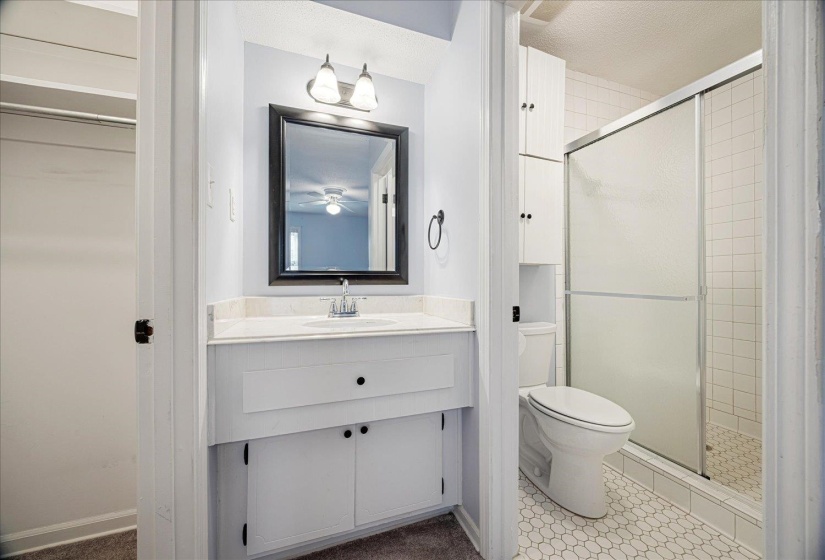 Bathroom featuring vanity, a stall shower, and tile patterned flooring