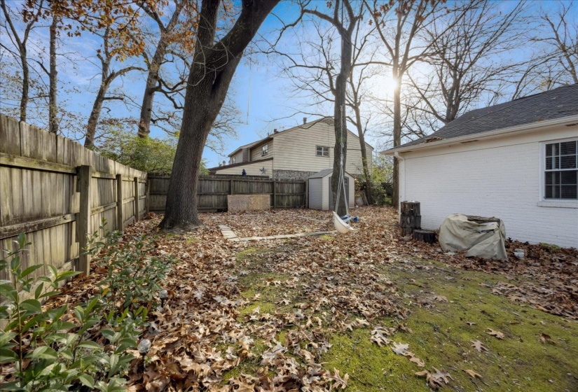 Fenced backyard with a storage shed